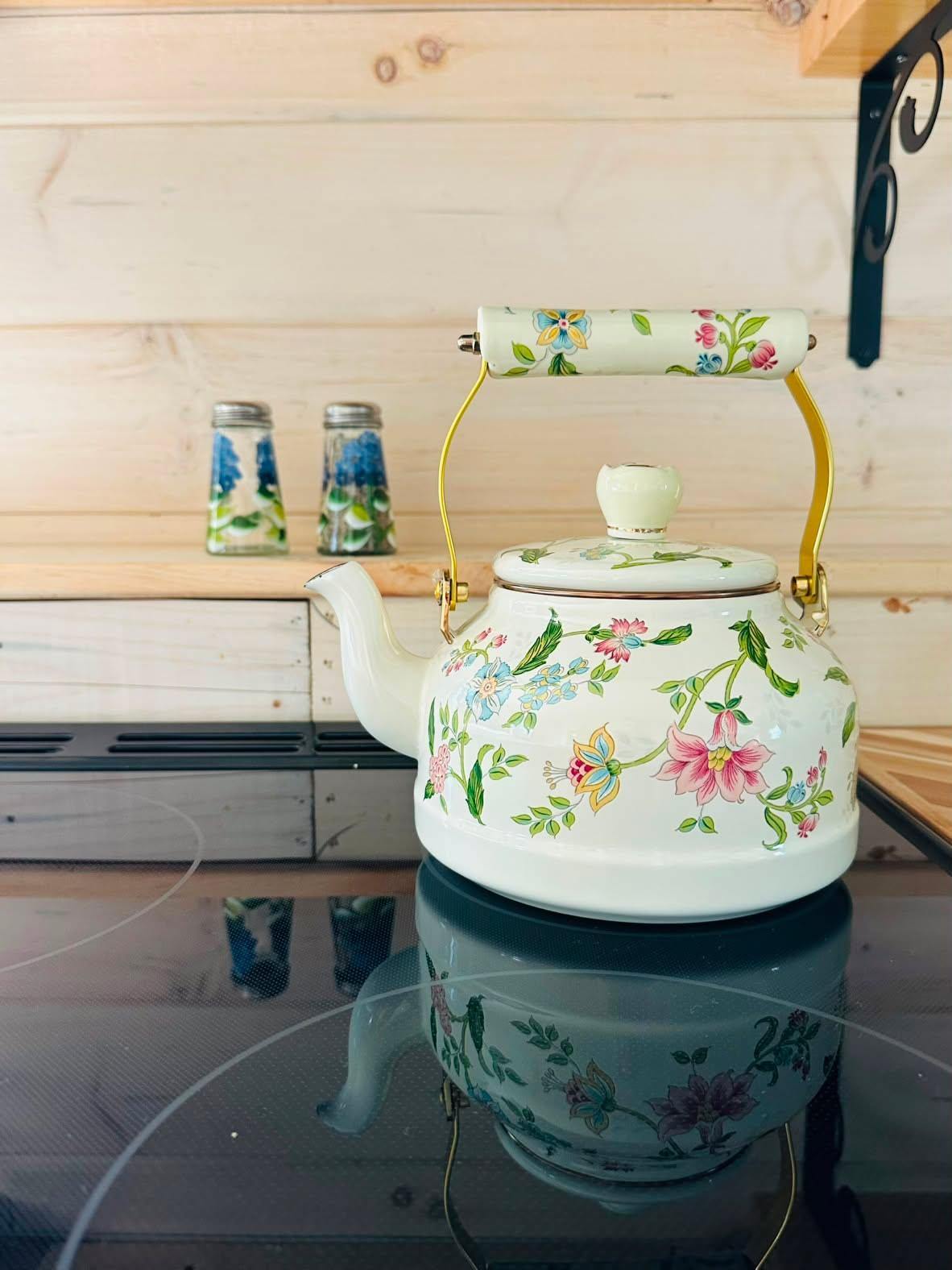 Floral enamel teakettle on the cottage stovetop