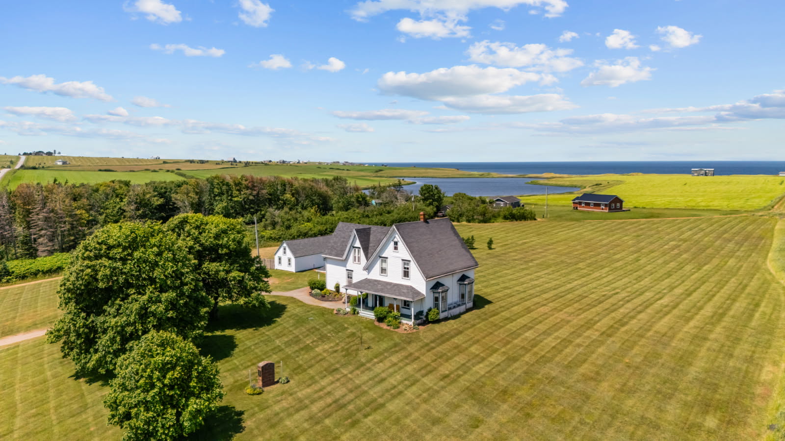 Aerial view of the Inn and Four Winds Cottage with the lake and ocean beyond